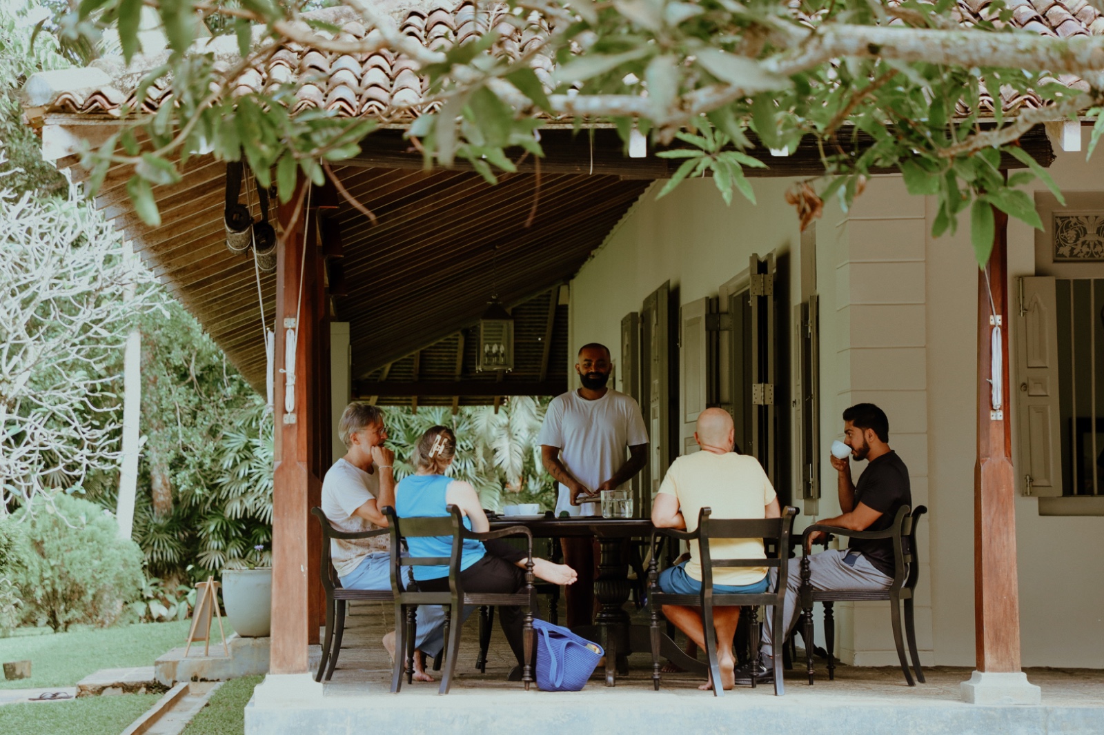 Leaders sharing a quiet meal on a verandah after practice