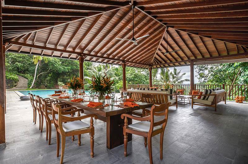 Open pavilion by the pool set for dinner